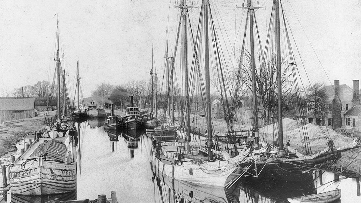 Vessels are moored in the Dismal Swamp Canal at South Mills in this circa 1900 photo from the North Carolina Collection, University of North Carolina at Chapel Hill Library.
