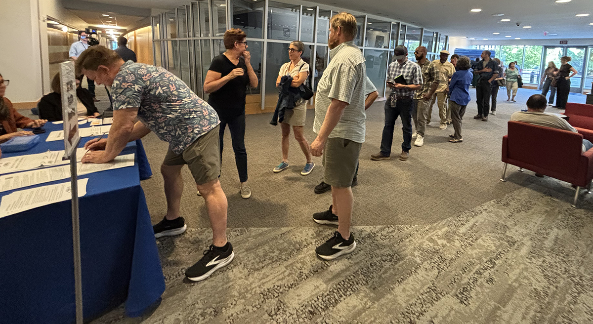 Hearing attendees sign up to speak Thursday at the Skyline Center in Wilmington. Photo: Trista Talton