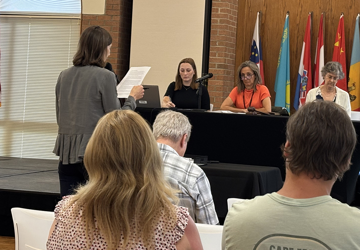 Southern Environmental Law Center attorney Kasey Moraveck speaks at the podium Tuesday in Fayetteville during a public hearing on proposed monitoring and minimization rules for industrial dischargers of 1,4-dioxane and the public sewage plants that accept their wastewater. Photo: Trista Talton