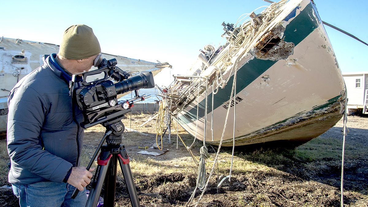 Videographer Paul Cronin shoots footage of the derelict concrete sailboats on the TowBoatUS lot awaiting transfer to the landfill in 2018. BoatUS Foundation was awarded a federal grant to remove derelict vessels and fishing nets from Beaufort Harbor. Photo: NOAA