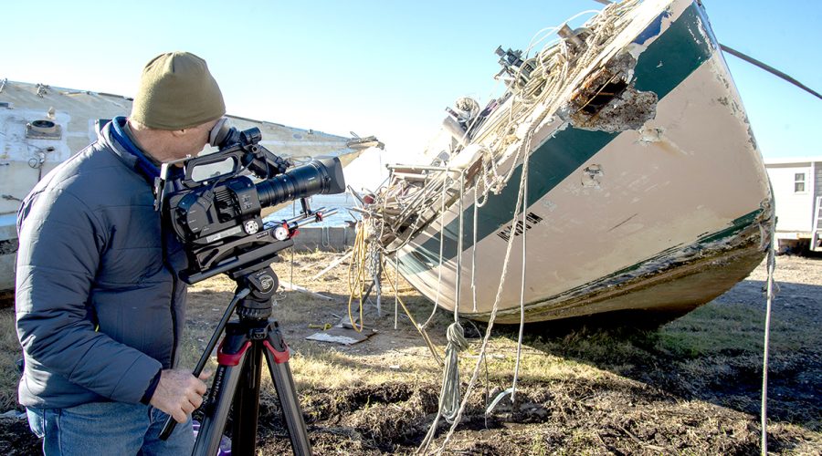 Videographer Paul Cronin shoots footage of the derelict concrete sailboats on the TowBoatUS lot awaiting transfer to the landfill in 2018. BoatUS Foundation was awarded a federal grant to remove derelict vessels and fishing nets from Beaufort Harbor. Photo: NOAA