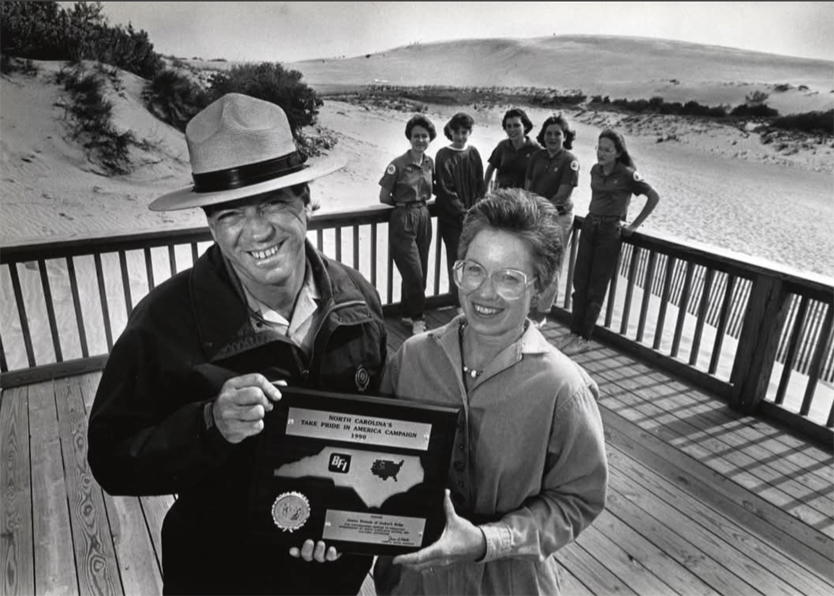 Jockeys Ridge State Park Superintendent George Barnes poses with Peggy Birkemeier of the Friends of Jockeys Ridge State Park and members of the staff in 1990.