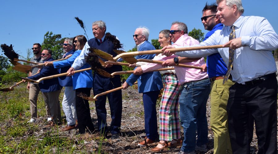 Officials including Sen. Norm Sanderson, fifth from left, Rep. Celest Cairns, fourth from left, and representatives of the Golden LEAF Foundation, Shellfish Growers Association, Carteret County and the North Carolina Coastal Federation sling their ceremonial shovels skyward during a groundbreaking event for the Shellfish Mariculture Hub at the Straits Landing boat ramp outside of Beaufort and near Harkers Island. Photo: Mark Hibbs