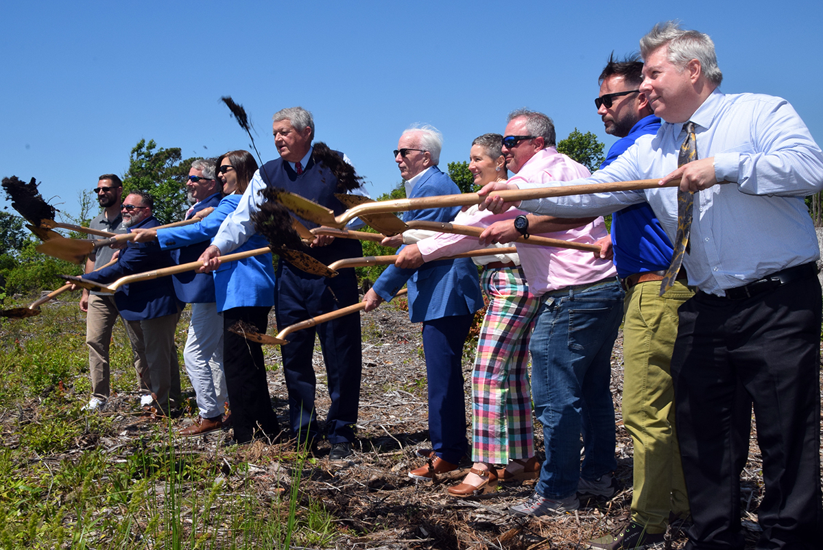 Officials including Sen. Norm Sanderson, fifth from left, Rep. Celest Cairns, fourth from left, and representatives of the Golden LEAF Foundation, Shellfish Growers Association, Carteret County and the North Carolina Coastal Federation sling their ceremonial shovels skyward during a groundbreaking event for the Shellfish Mariculture Hub at the Straits Landing boat ramp outside of Beaufort and near Harkers Island. Photo: Mark Hibbs