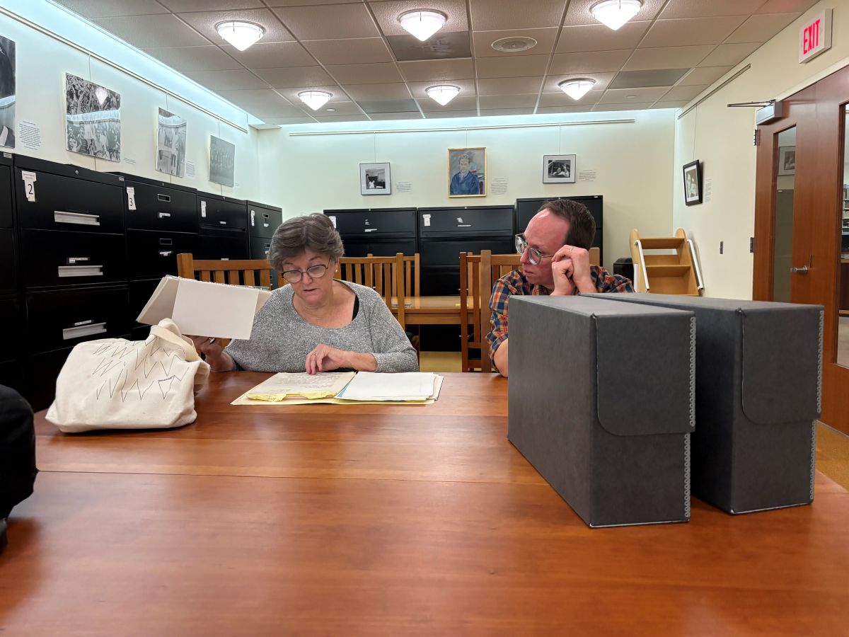 Karen Amspacher, left, sorts through documents  in Appalachian State University's Special Collections Research Center with oral historian, Mark Coltrain, in October 2025. Photo: Shannon Adams