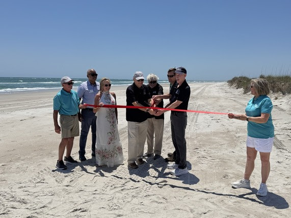 From right, N.C. Department of Environmental Quality Secretary Reid Wilson, Division of Coastal Management Conservation Coordinator Jonathan Lucas, Topsail Beach Mayor Frank Braxton, and N.C. Coastal Land Trust Executive Director Harrison Marks cut a ribbon Tuesday to mark the transfer of the Topsail Nature Preserve to state management. Photo contributed