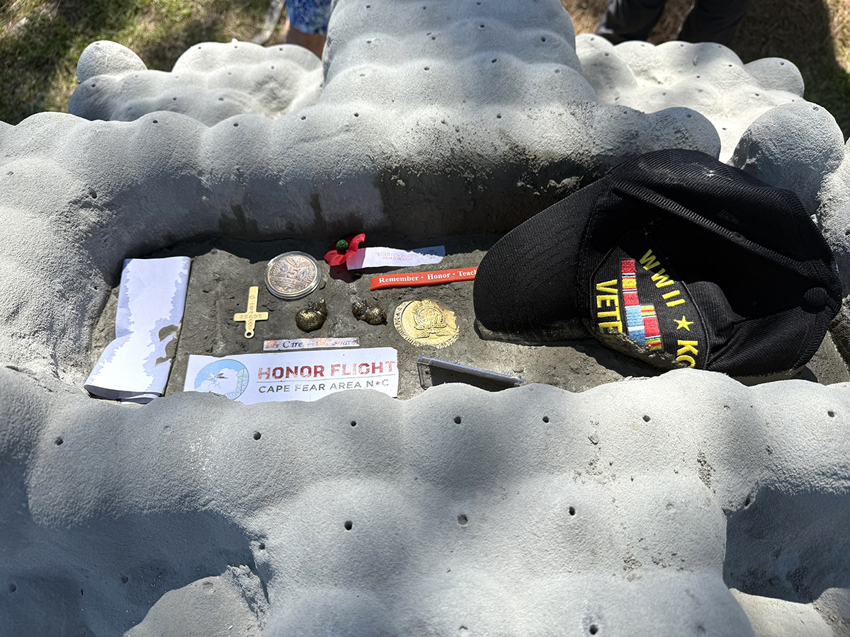 A World War II and Korean War veteran's personal effects are placed Friday in a memorial eco-positive reef module. Photo: Vivian Yuditsky