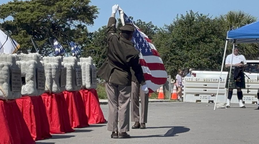 Service members fold an American Flag Saturday as the Veterans Memorial Reef held its sixth annual three-day event this past weekend in Southport, interring the ashes of six veterans and three spouses of veterans in memorial markers to be lowered into the sea on Monday. Photo: Vivian Yuditsky