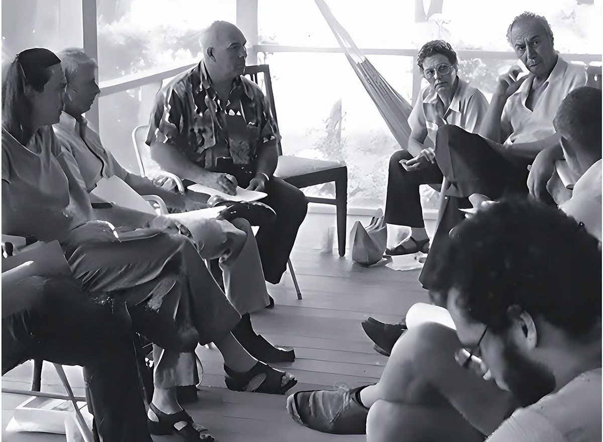 The North Carolina Coastal Federation holds a board meeting on porch at the home of founder Todd Miller, bottom right, in 1986. Photo: North Carolina Coastal Federation archives
