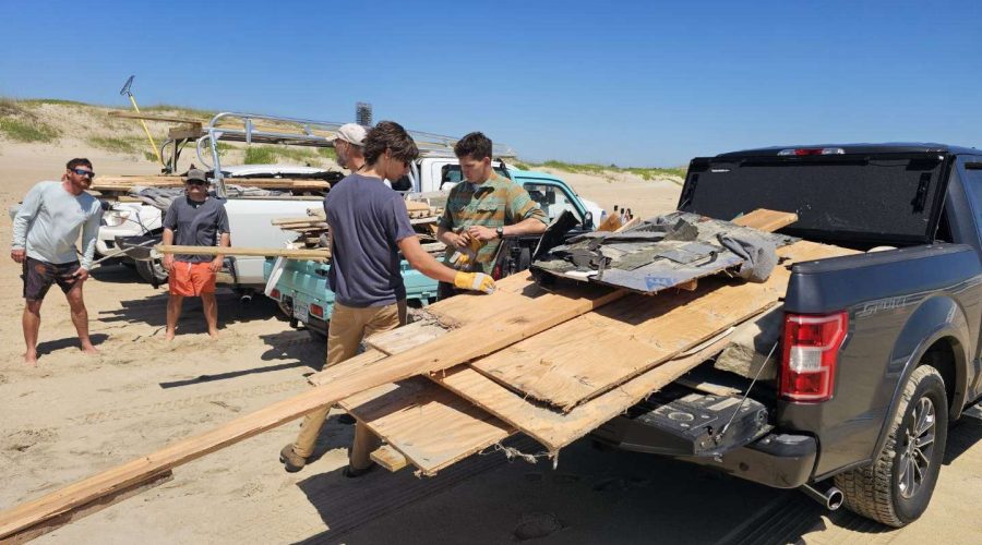 Volunteers on Wednesday load debris from the collapsed house into the bed of a pickup truck. Photo:Dan Rothermel