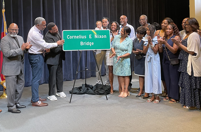 Nixon family members and representatives of the N.C. Department of Transportation and the Nixon Leadership Center at Cape Fear Community College in Wilmington unveil the Cornelius E. Nixon Bridge sign slated for the Military Cutoff Overpass above Market Street during a dedication ceremony April 24 at Cape Fear Community College. Photo: Liz Biro
