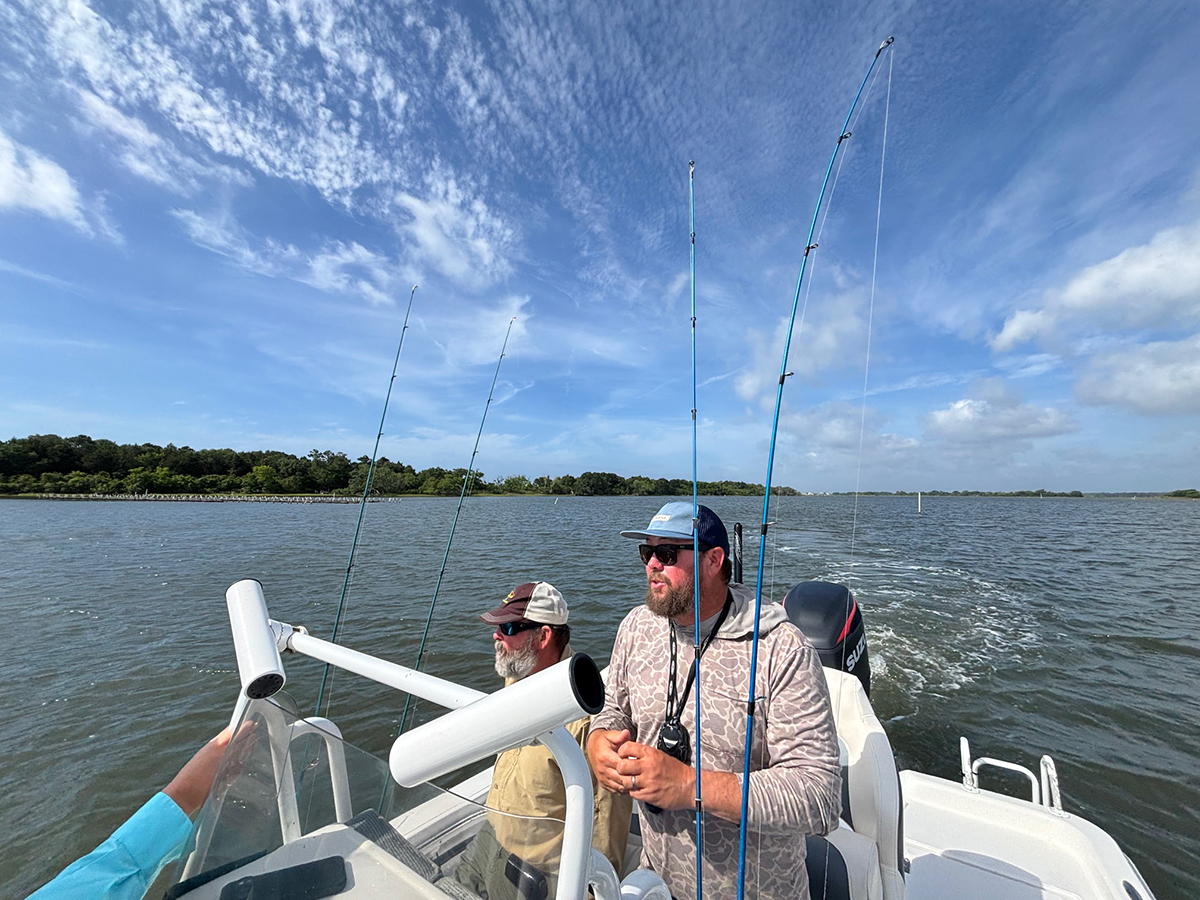 Fishing guide Capt. Ray Brittain, center, along with fellow guide Capt. Mike Oppegaard, talk about how the growing number of shellfish farms behind the waters of Topsail Island affect their businesses. Photo: Trista Talton