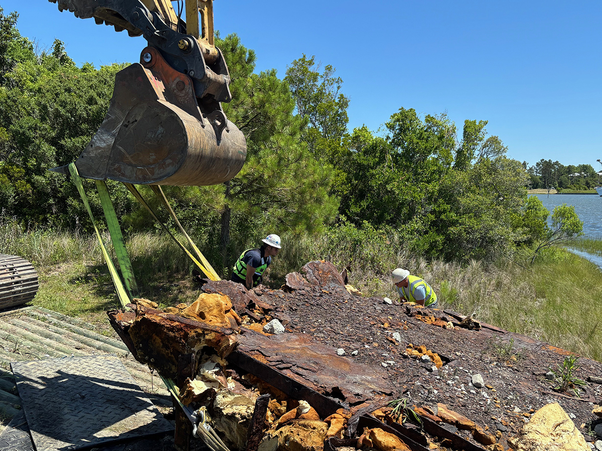 This abandoned barge was one of two removed from waters in Sneads Ferry on Wednesday. Photo: Trista Talton