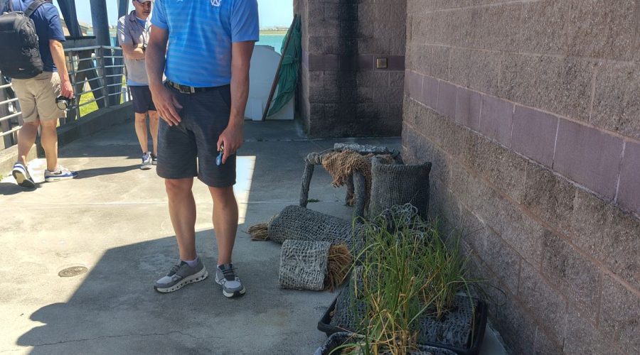 Dr. Joel Fodrie, director of UNC Institute of Marine Sciences, explains that the lab is working with companies that create different types of structures to build living shorelines refine their product. Photo: Jennifer Allen
