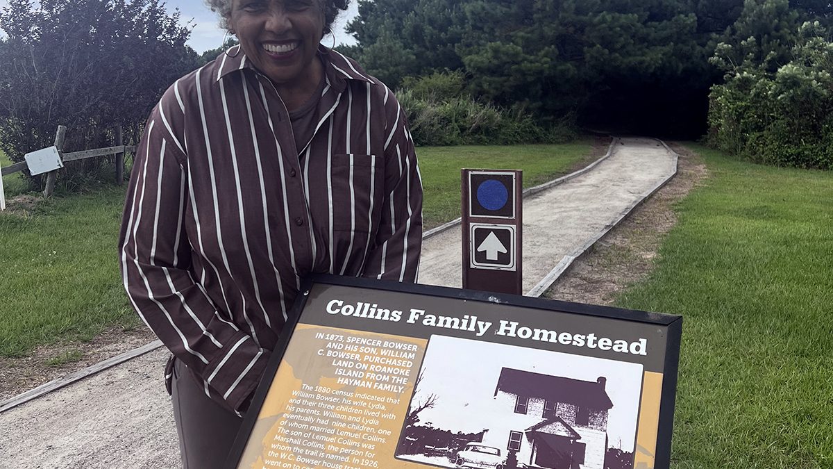 Joan Collins poses at the Marshall and Gussie Collins Walkway on Roanoke Island.