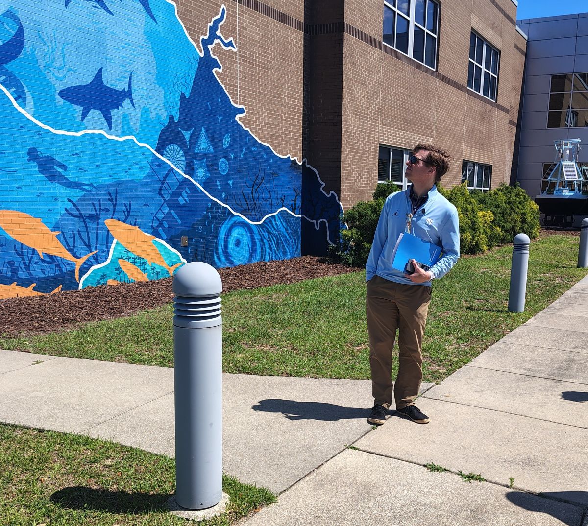 UNC Chancellor Lee H. Roberts glances at the mural Tuesday outside of the Institute of Marine Sciences lab in Morehead City. Photo: Jennifer Allen