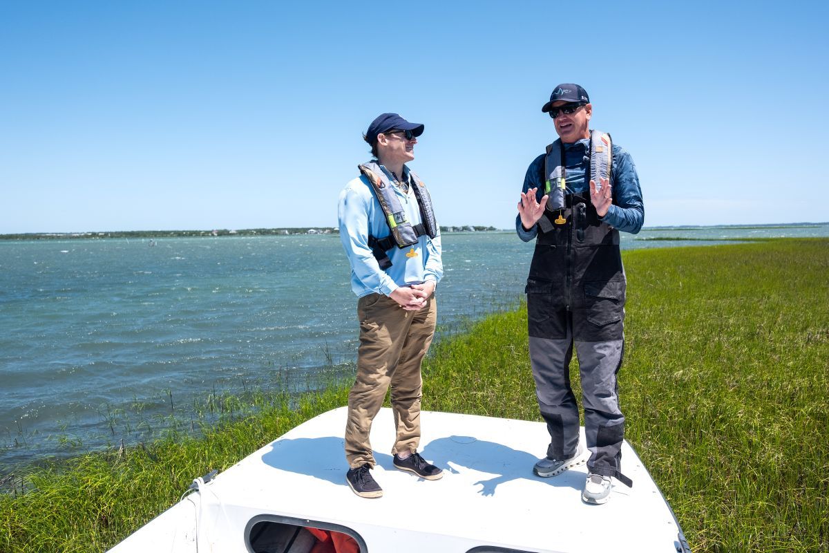 UNC Chancellor Lee H. Roberts, left, listens as IMS Director Dr. Joel Fodrie,gives an overview of the coastal ecosystems in the area. Photo: Jon Gardiner/UNC-Chapel Hill