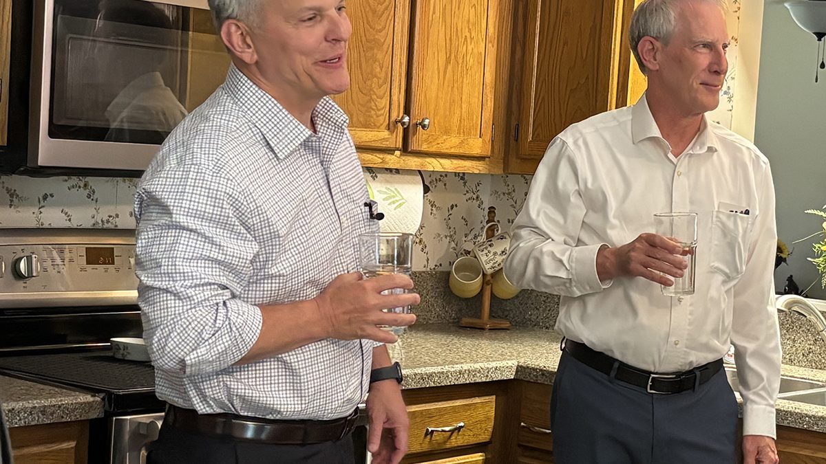 North Carolina Gov. Josh Stein, left, and Department of Environmental Quality Secretary Reid Wilson taste water Brenda Moore served from the kitchen tap in her Wilmington-area home on Wednesday. Photo: Trista Talton