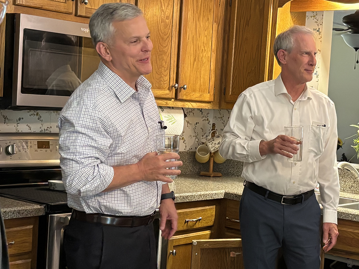 North Carolina Gov. Josh Stein, left, and Department of Environmental Quality Secretary Reid Wilson taste water Brenda Moore served from the kitchen tap in her Wilmington-area home on Wednesday. Photo: Trista Talton