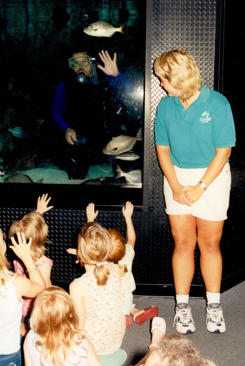 A diver waves to young visitors from the "Living Shipwreck" exhibit before the facility was renovated. Photo: N.C. Aquariums