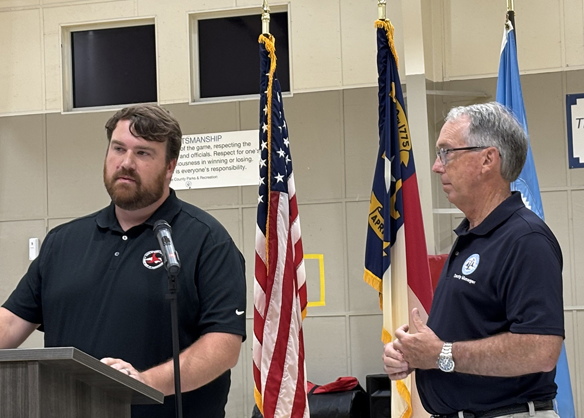 North Carolina Department of Transportation Deputy Division 1 Engineer Marshall Gill and Bobby Outten, the Dare County manager and attorney, speak Tuesday during a public meeting at the Fessenden Center in Buxton. Photo: Catherine Kozak