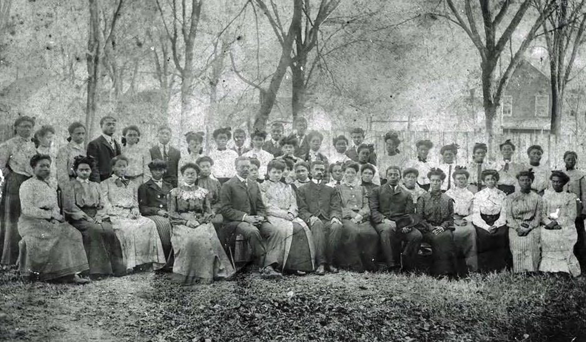 Students and faculty array around Principal Peter W. Moore, apparently on Commencement Day. Before the permanent campus opened in 1912, local churches hosted the State Normal School’s commencement ceremonies. Courtesy, University Archives, Elizabeth City State University