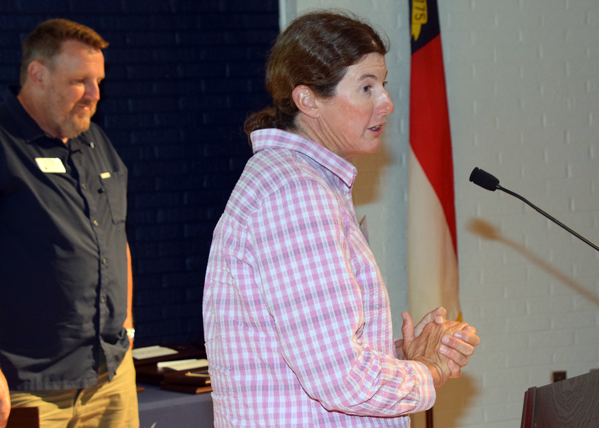Coastal biologist Lindsay Addison, right, of Audubon North Carolina, accepts her award from North Carolina Coastal Federation Coastal Scientist and Marine Debris Program Director Ted Wilgus Saturday in Morehead City. Photo: Mark Hibbs