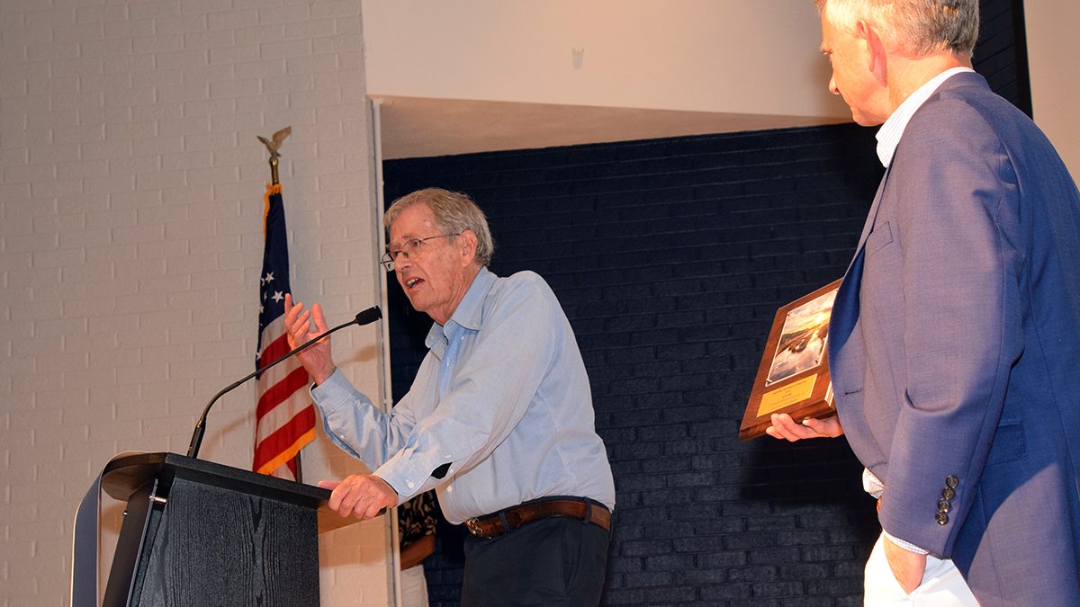 Dr. Stan Riggs, left, accepts his Pelican Award “For Distinguished Leadership and Lifetime Excellence in Coastal Research, Science, and Stewardship” from North Carolina Coastal Federation Executive Director Braxton Davis Saturday in Morehead City. Photo: Mark Hibbs