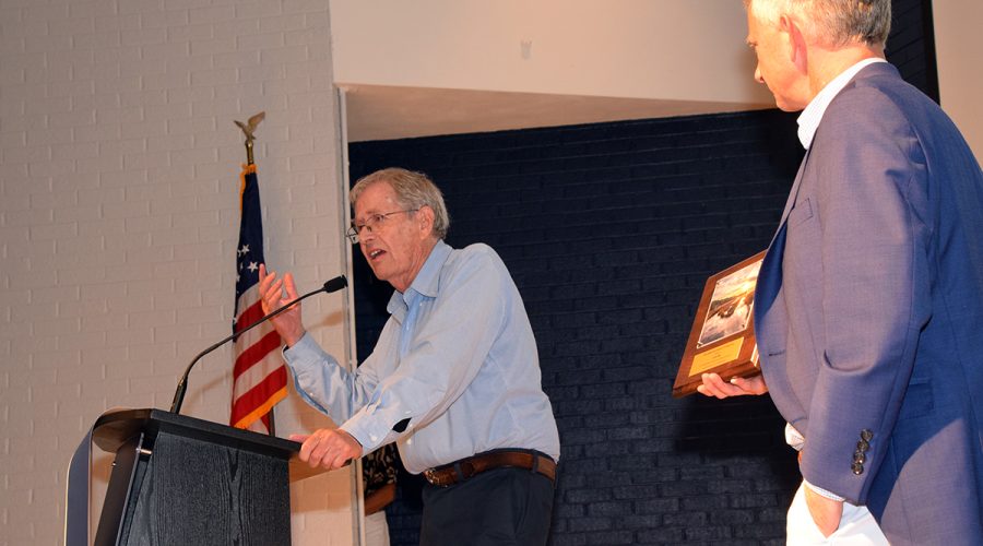 Dr. Stan Riggs, left, accepts his Pelican Award “For Distinguished Leadership and Lifetime Excellence in Coastal Research, Science, and Stewardship” from North Carolina Coastal Federation Executive Director Braxton Davis Saturday in Morehead City. Photo: Mark Hibbs