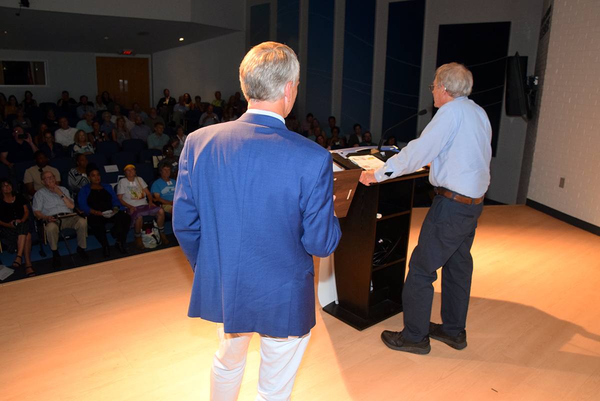 North Carolina Coastal Federation Executive Director Braxton Davis, left, looks on Saturday as Dr. Stan Riggs speaks during the nonprofit organization's 23rd annual Pelican Awards in Joslyn Hall on the Carteret Community College campus in Morehead City. Photo: Mark Hibbs