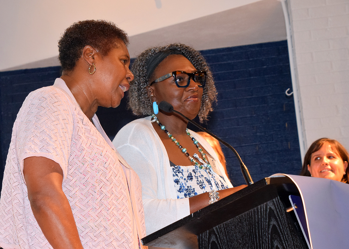 North River Laurel Road Outreach Committee President Matilda Stewart, right, and Vice President Mary Ann Monroe extend accept their Pelican Award for “For Grassroots Leadership Advancing Coastal Resilience and Community Action” as coastal education coordinator Rachel Bisesi looks on. Photo: Mark Hibbs