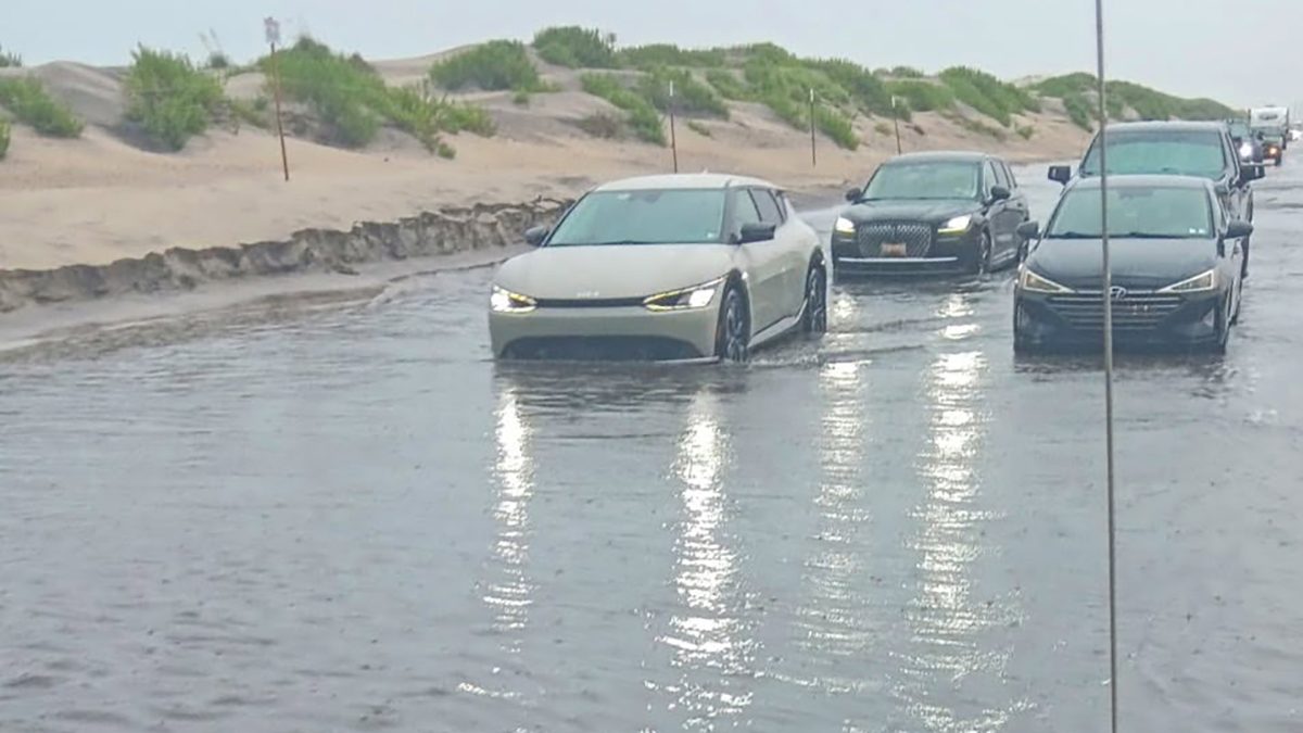 Motorists navigate a flooded N.C. Highway 12 on Pea Island during a rainstorm in July that prompted state transportation officials to temporarily close the only route in or out. Photo: NCDOT