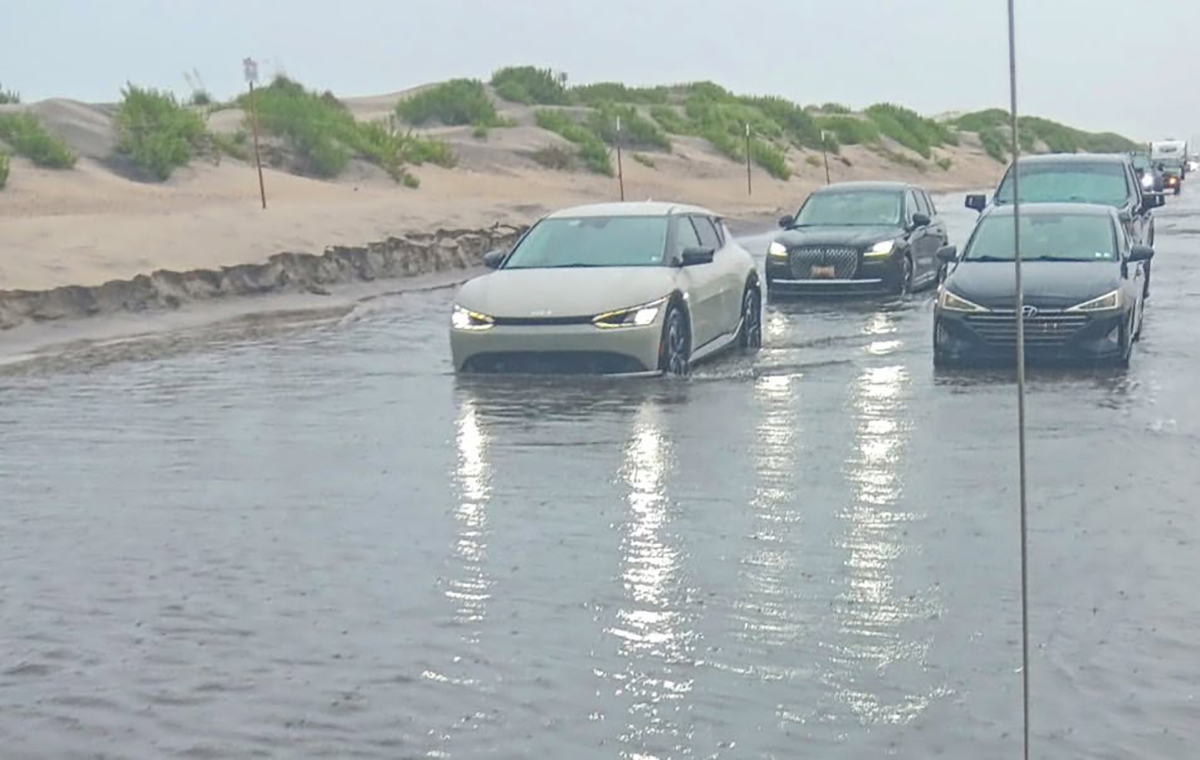Motorists attempt travel July 24 on N.C. Highway 12 on Pea Island through standing water from rainstorms that dumped as much as 7 inches in places over a 36-hour period. Photo: NCDOT