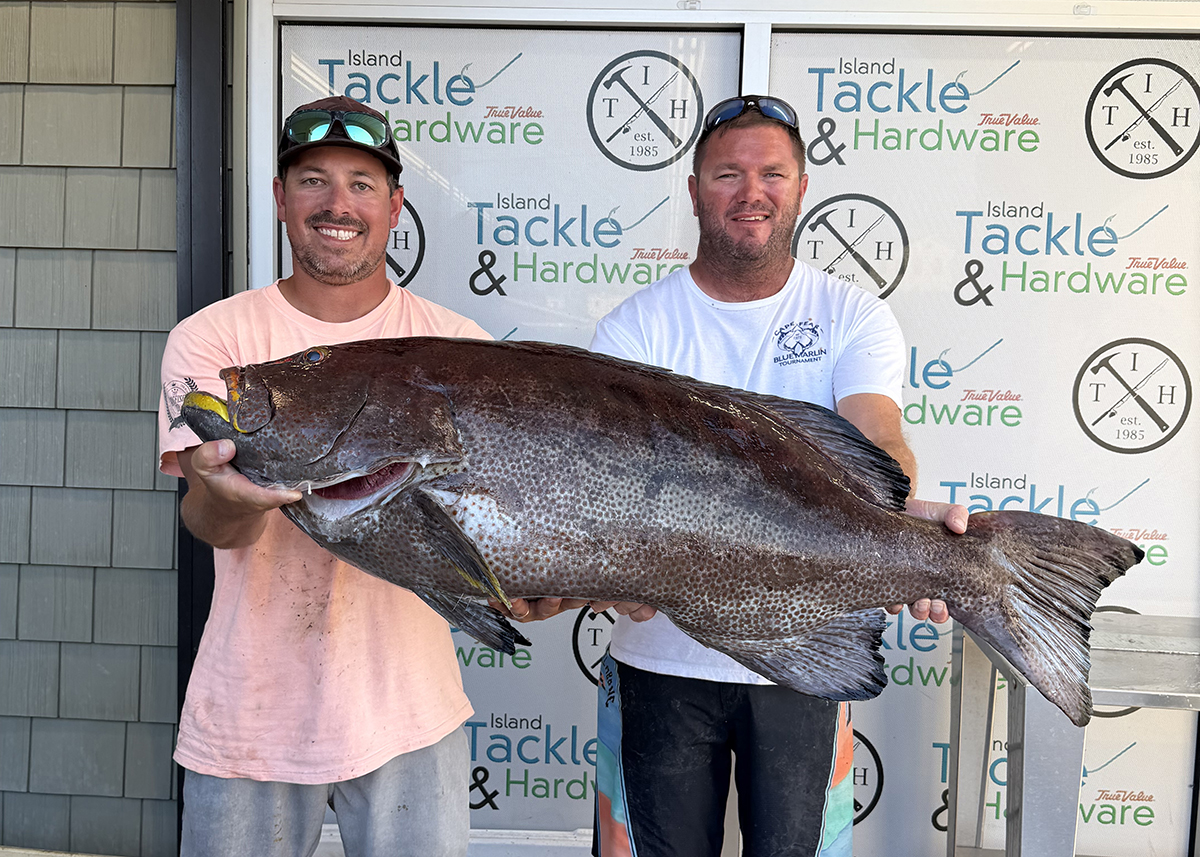 John Theodorakis, left, and his friend, Austin Eubank display the new state record yellowfin grouper landed July 2. Photo: Division of Marine Fisheries