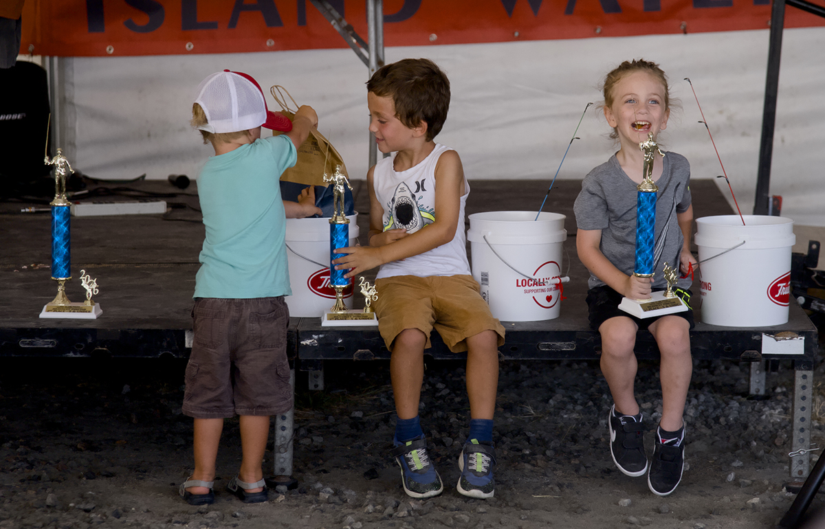 Young fishing contest participants celebrate the outcome. Photo: Kip Tabb