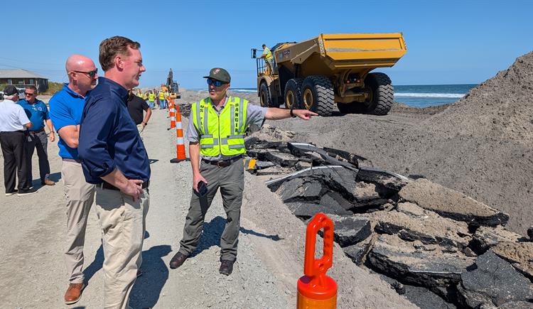 State transportation officials reopened N.C. 12 on Pea Island at 3 p.m. Tuesday using a one-lane gravel road to move traffic north. It's the first time N.C. 12 on Pea Island has opened to traffic since Sept. 24. Above, NCDOT Secretary Daniel Johnson surveys damage on N.C. 12. Photo: NCDOT