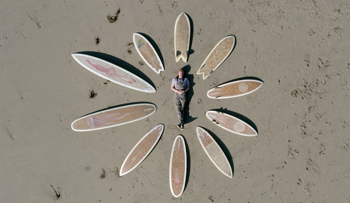 Film coproducer Taylor Lane poses with the 10 cigarette surfboards he created. Photo contributed.