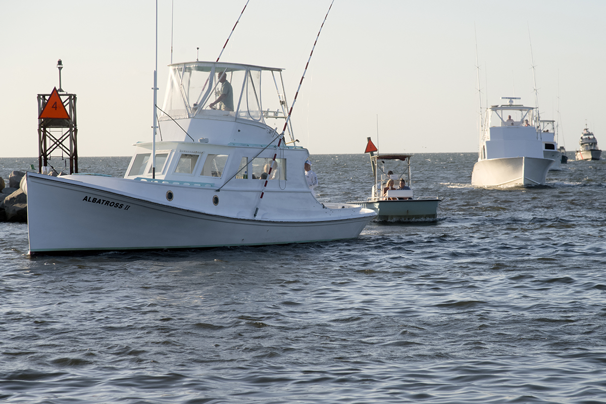 Led by the Albatross II, the Hatteras fishing fleet arrives at port to be blessed Saturday during the 22nd annual Day at the Docks in Hatteras Village. Photo: Kip Tabb