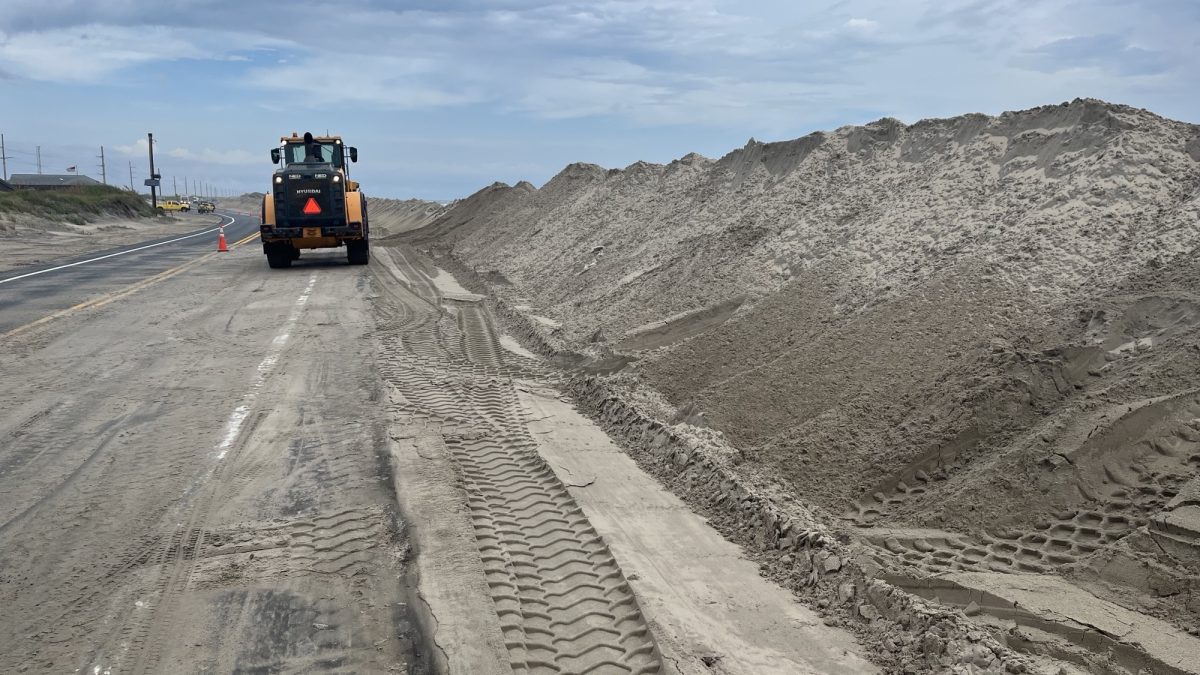 NCDOT crews work to fortify protective dunes on Pea Island, Tuesday ahead of a storm developing off the Outer Banks. Photo: NCDOT