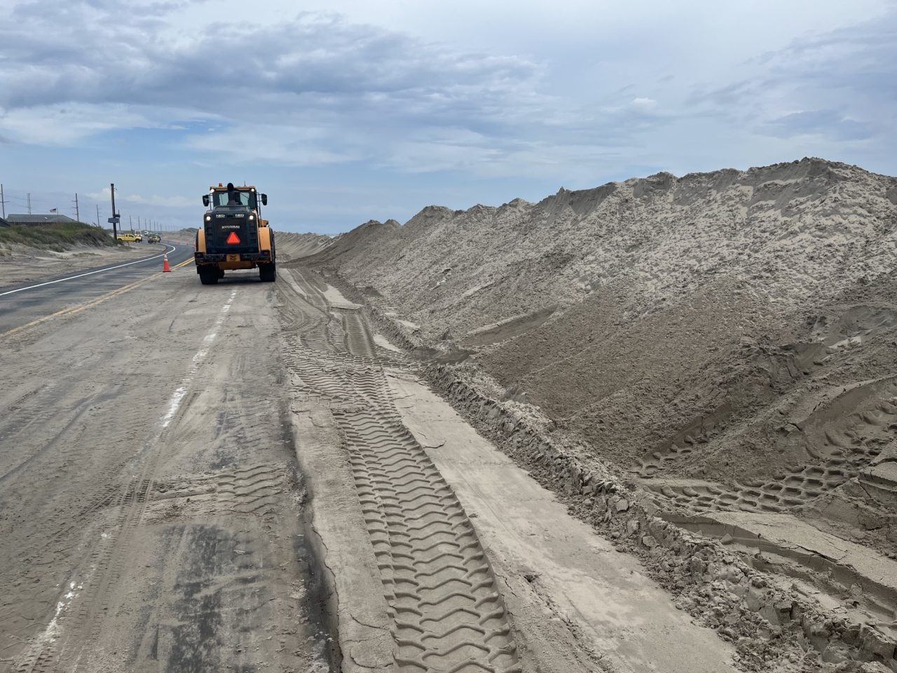NCDOT crews work to fortify protective dunes on Pea Island, Tuesday ahead of a storm developing off the Outer Banks. Photo: NCDOT