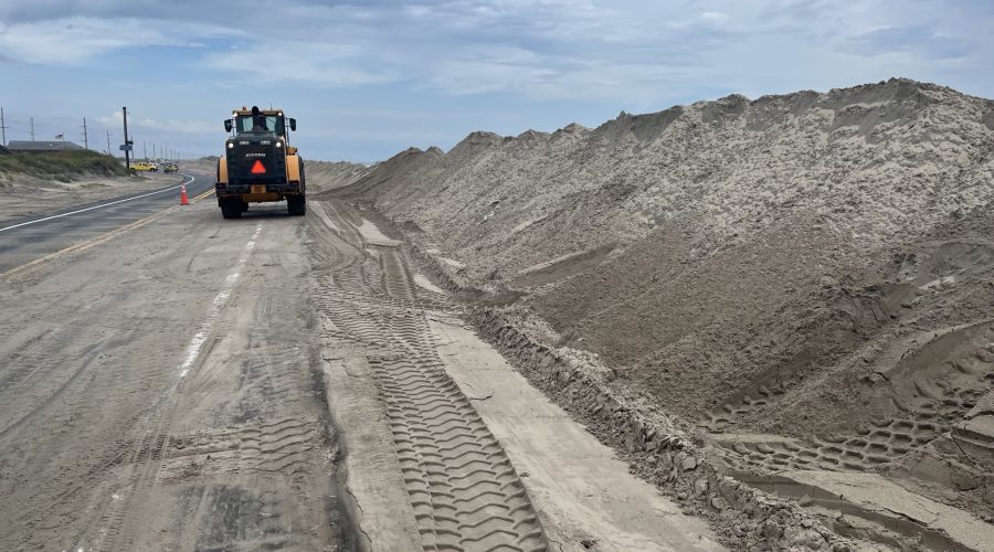 NCDOT crews work to fortify protective dunes on Pea Island, Tuesday ahead of a storm developing off the Outer Banks. Photo: NCDOT