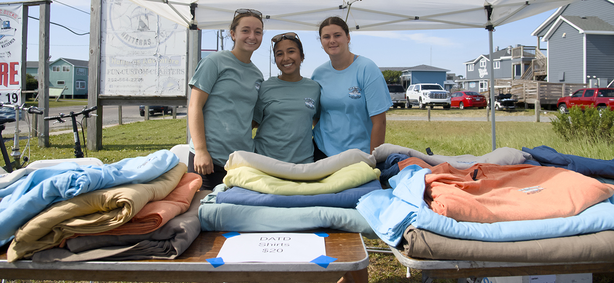 Cape Hatteras Secondary School students, from left, Ella Snead, Jeidy Garcia, Taylor Hickman, volunteer Saturday for Day at the Docks. Photo: Kip Tabb