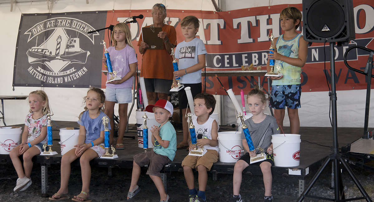 It was a great day for landing pinfish. Prizewinners of the youth fishing contest fill the stage. Photo: Kip Tabb