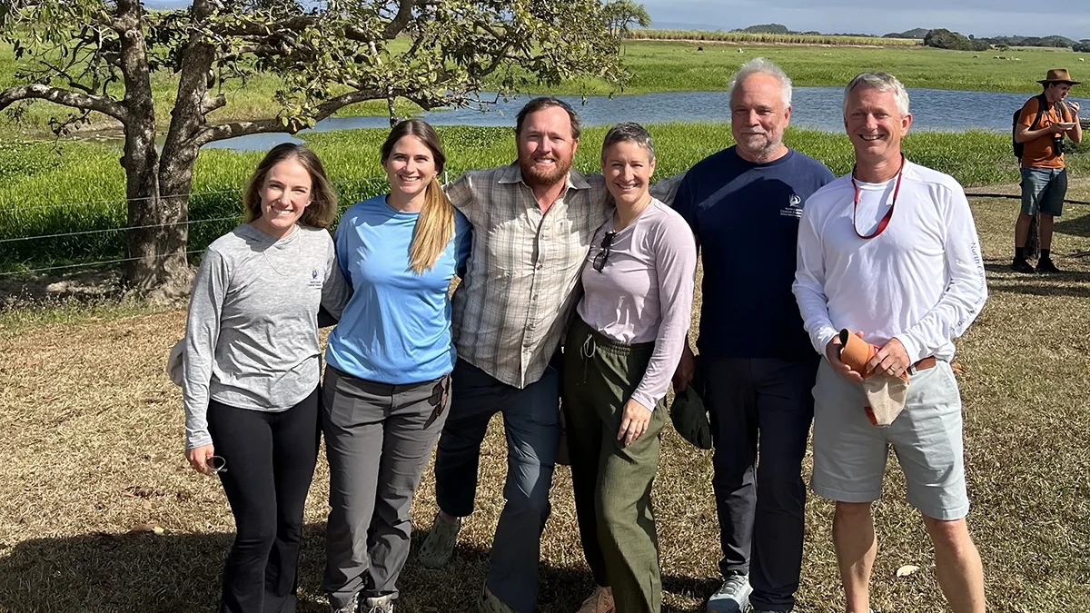 North Carolina Coastal Federation staff, from left, Oyster Program Director Alyson Flynn, Water Quality Program Director Bree Charron, Salt Marsh Program Director Jacob Boyd, Chief Program Officer Ana Zivanovic-Nenadovic, founder Todd Miller and Executive Director Dr. Braxton Davis pose in a coastal area of Australia. Photo: North Carolina Coastal Federation