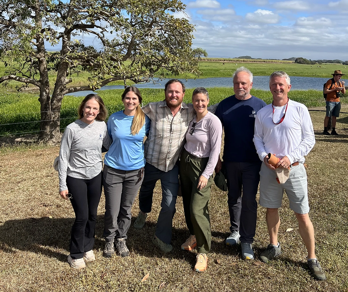 North Carolina Coastal Federation staff, from left, Oyster Program Director Alyson Flynn, Water Quality Program Director Bree Charron, Salt Marsh Program Director Jacob Boyd, Chief Program Officer Ana Zivanovic-Nenadovic, founder Todd Miller and Executive Director Dr. Braxton Davis pose in a coastal area of Australia. Photo: North Carolina Coastal Federation