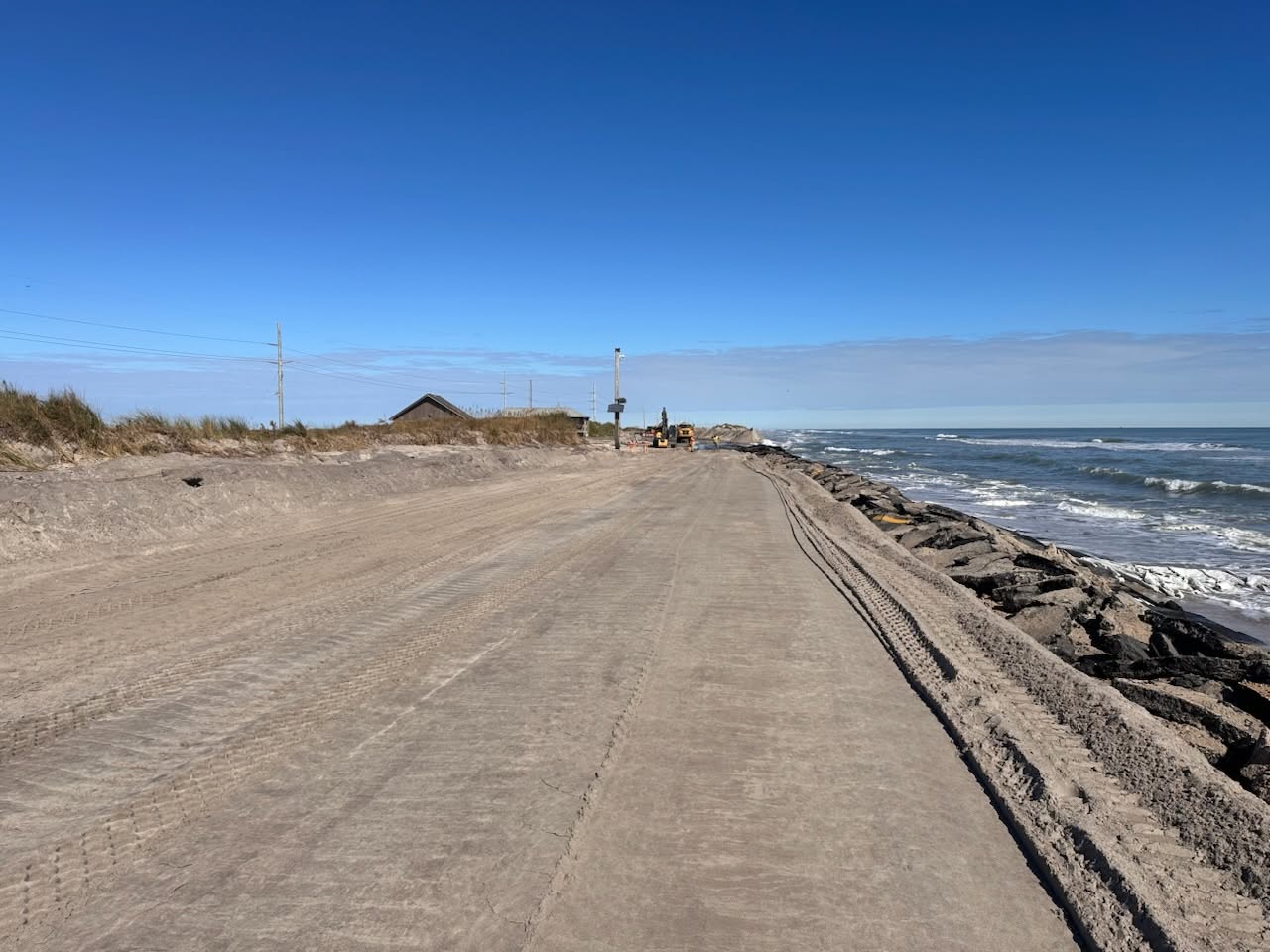 N.C. Department of Transportation crews work Monday to rebuild N.C. 12 between the Marc Basnight Bridge and Rodanthe. Photo; NCDOT