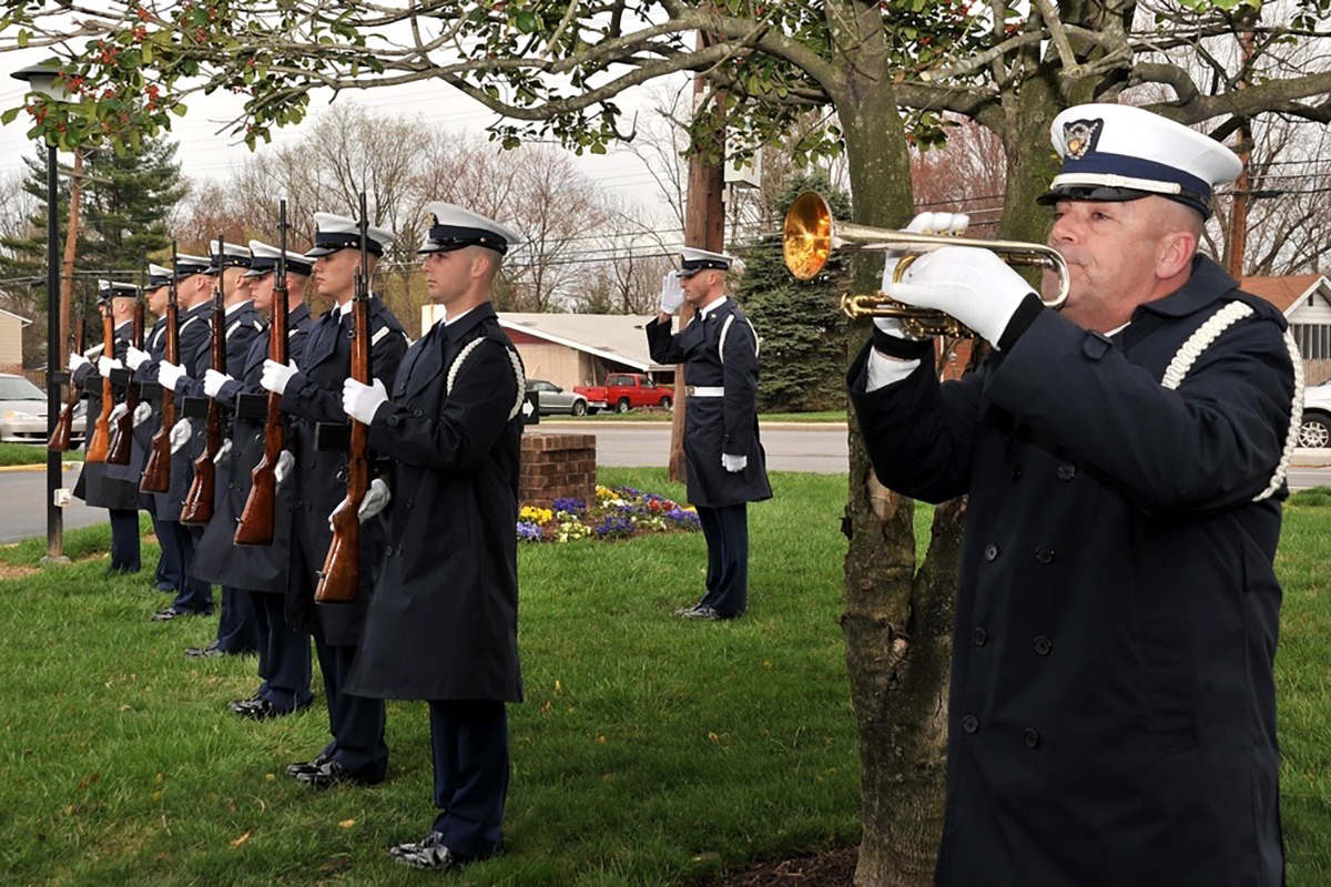 A U.S. Coast Guard bugler and Ceremonial Honor Guard are shown outside the memorial service for Lt. Herbert M. Collins in March 2010. Photo: U.S. Coast Guard