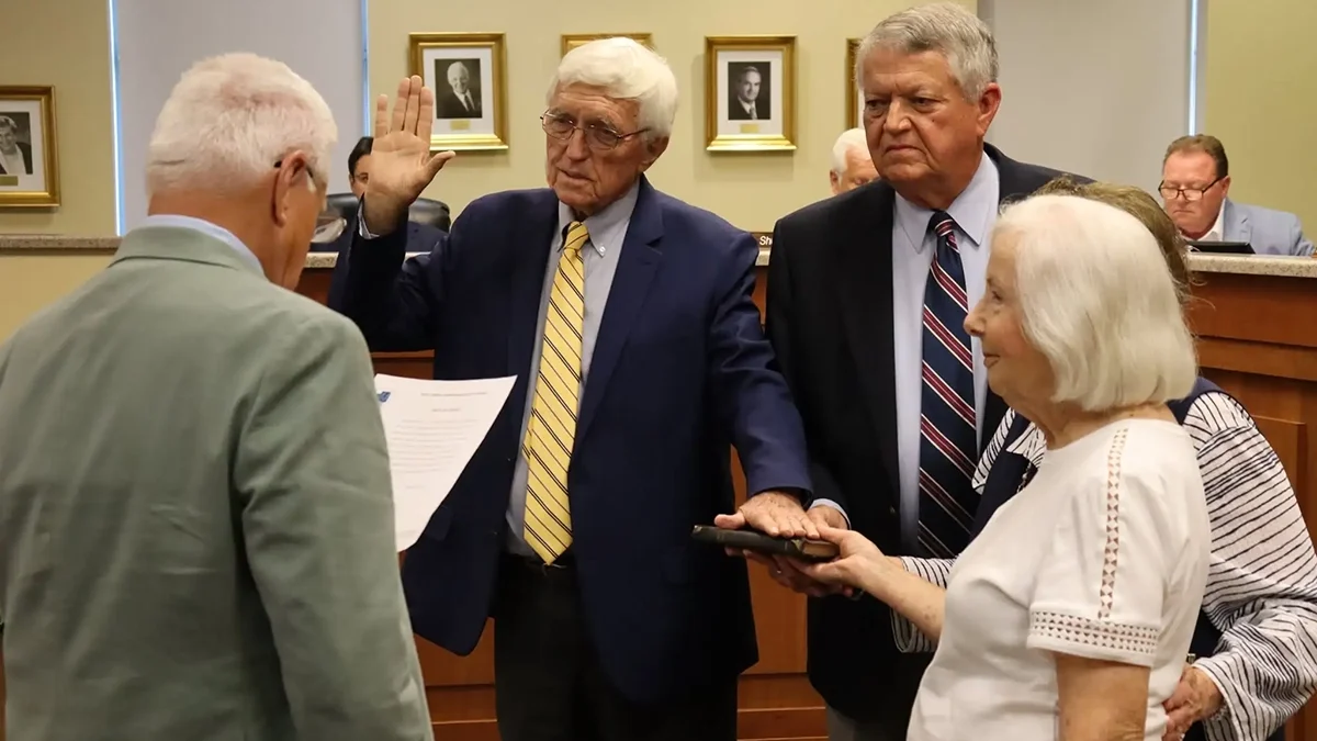 Retired Superior Court Judge Jerry Tillett administers the the oath of office for the North Carolina Coastal Resources Commission during the commission's meeting Aug. 26 in Manteo. Among those assisting is Sen. Norm Sanderson, R-Pamlico, his wife, and Linda Sanderson, and Hollowell's longtime partner, Carolyn Meadows. Photo courtesy of Christina Williams. 